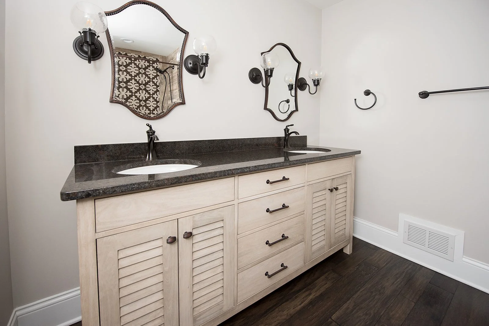 Completed bathroom remodel with a tiled tub surround and custom vanity