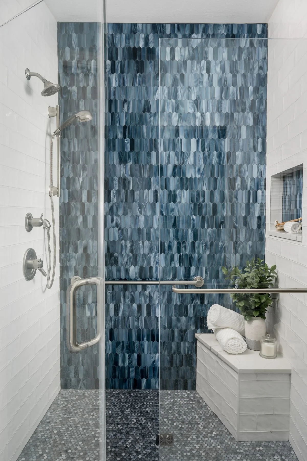 Primary bathroom renovation in Fishers with deep blue vanity cabinetry and a freestanding tub