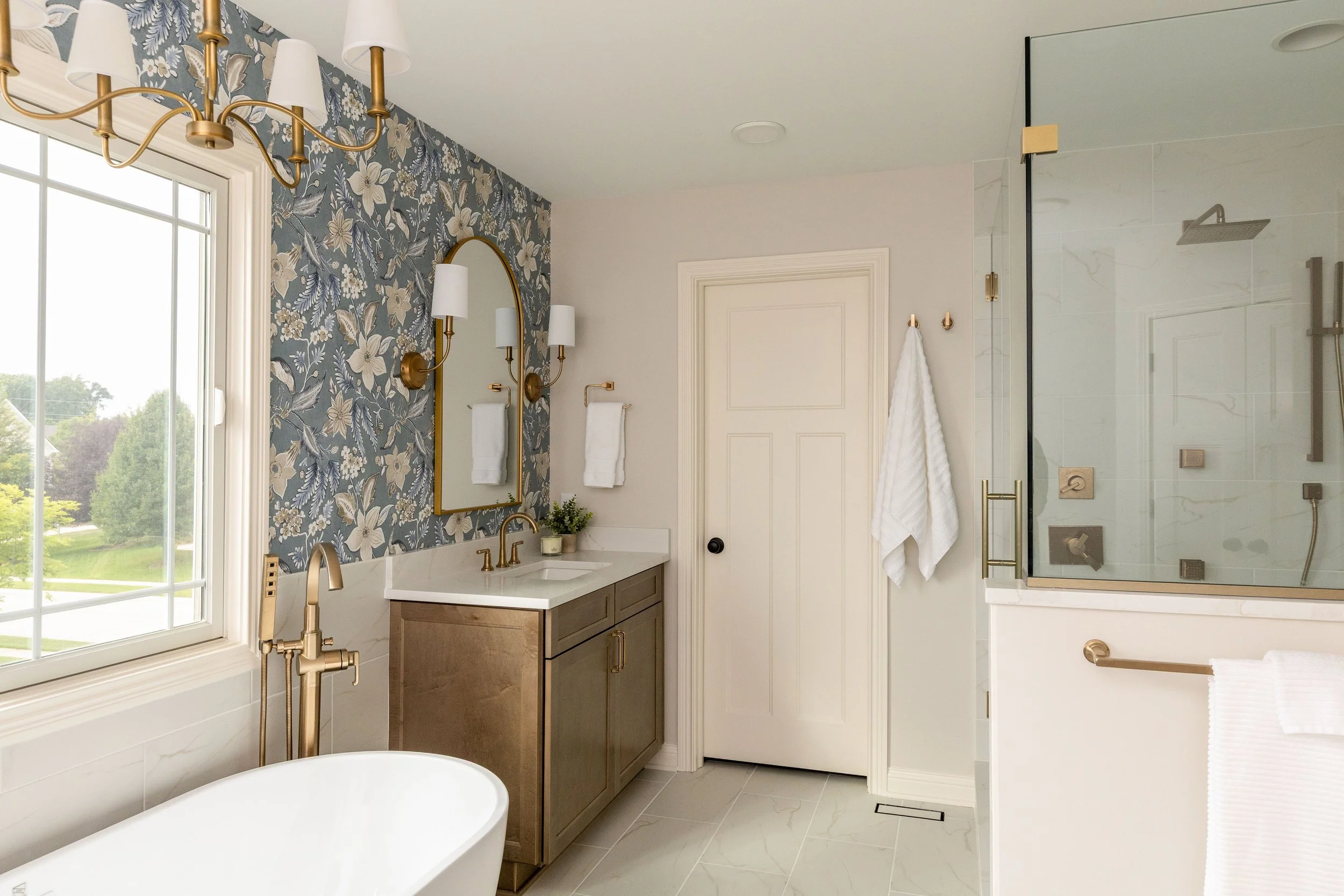 Zionsville bathroom remodel with panelled millwork, marble surfaces and classic fittings