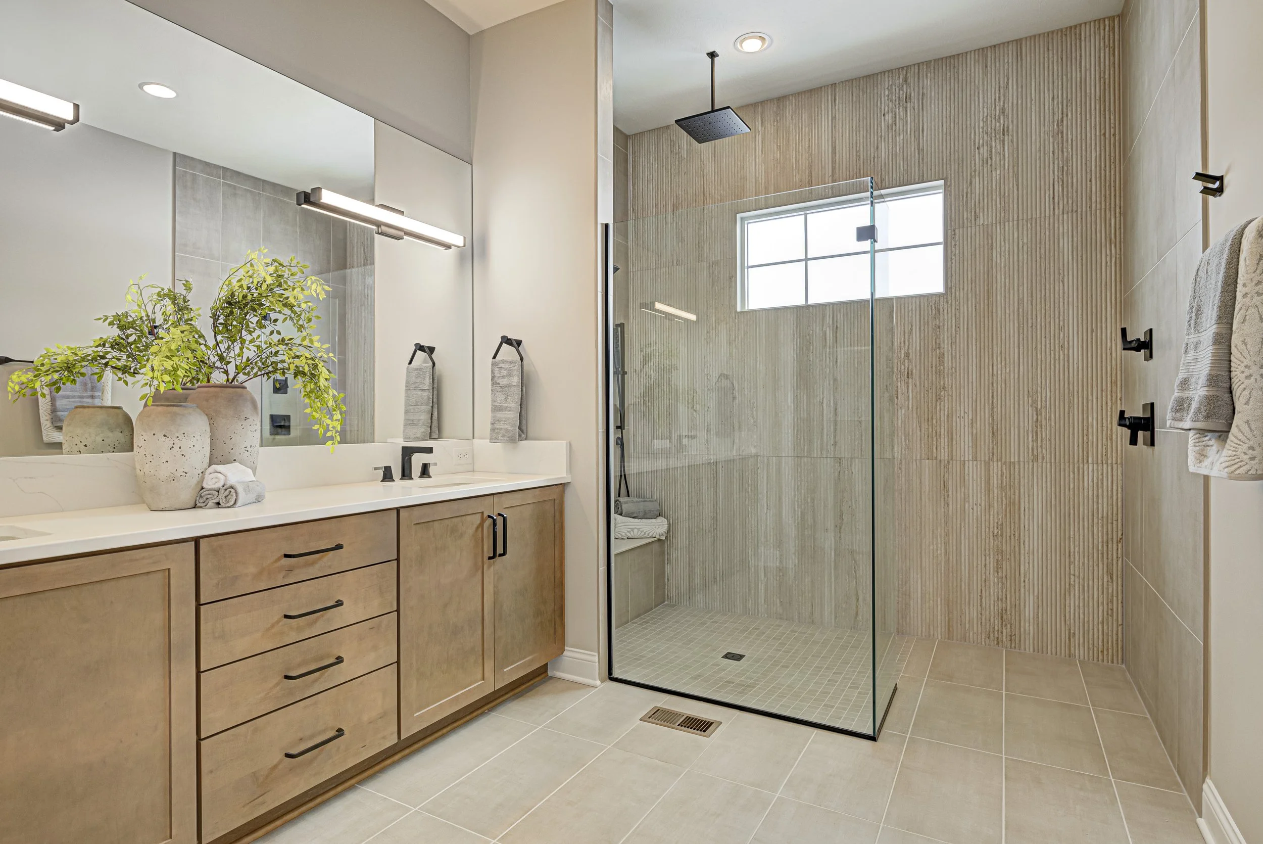 Custom primary bathroom in Westfield with natural stone, timber vanity and a soaking tub